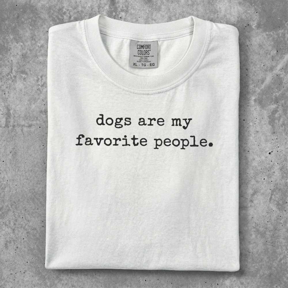 White t-shirt with "dogs are my favorite people" printed in black text.