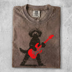 Brown t-shirt with a black silhouette of a dog playing a red electric guitar.