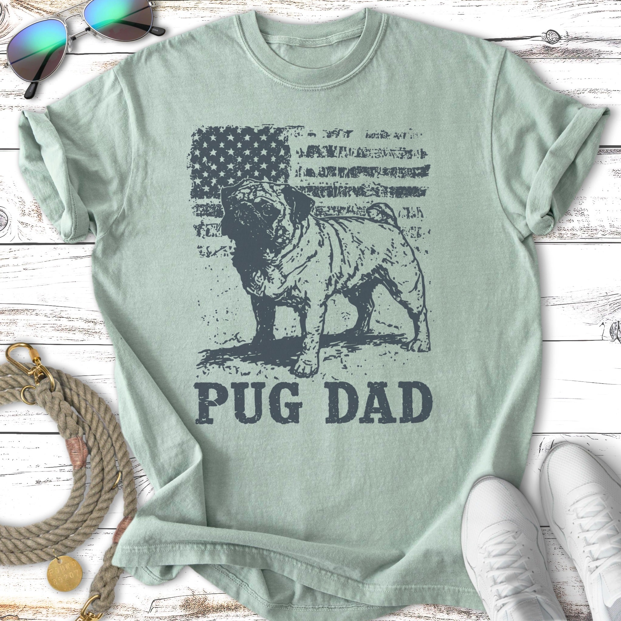 Pug dad graphic on a light green t-shirt with American flag design.