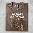 Skeleton in hammock eating tacos with dog, cacti, and moon.