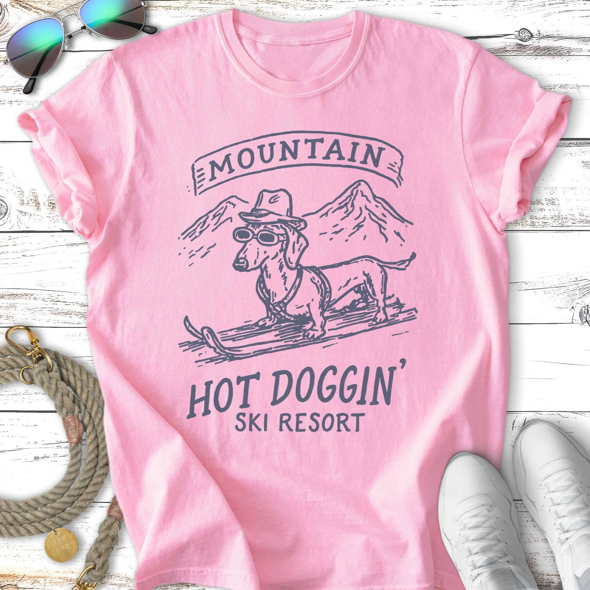 Pink t-shirt with dachshund in sunglasses on skis, "Mountain Hot Doggin' Ski Resort" text.
