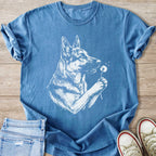 Blue t-shirt with a white sketch of a German Shepherd holding a dandelion.