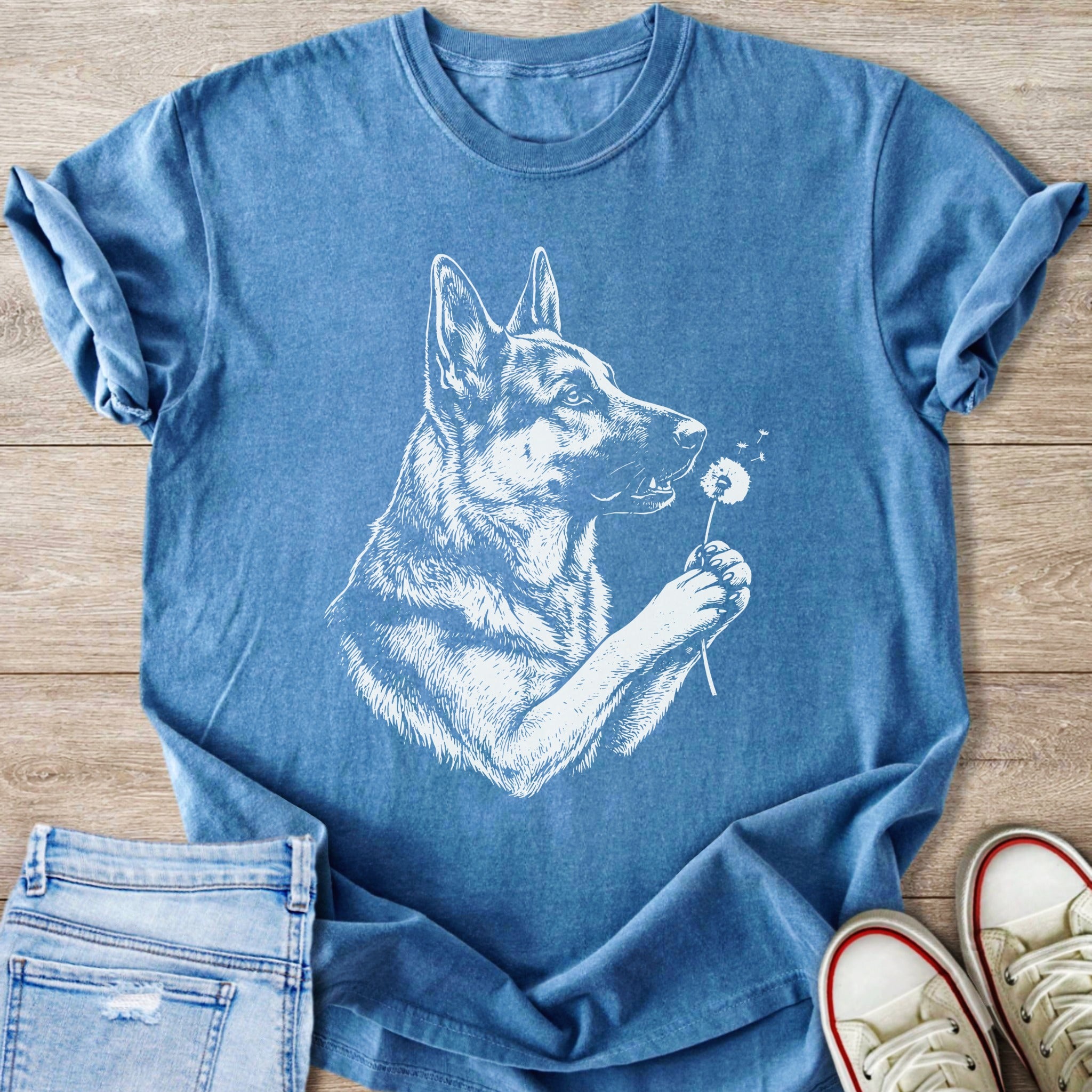 Blue t-shirt with a white sketch of a German Shepherd holding a dandelion.