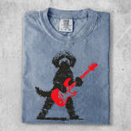 Distressed black poodle playing a red electric guitar.