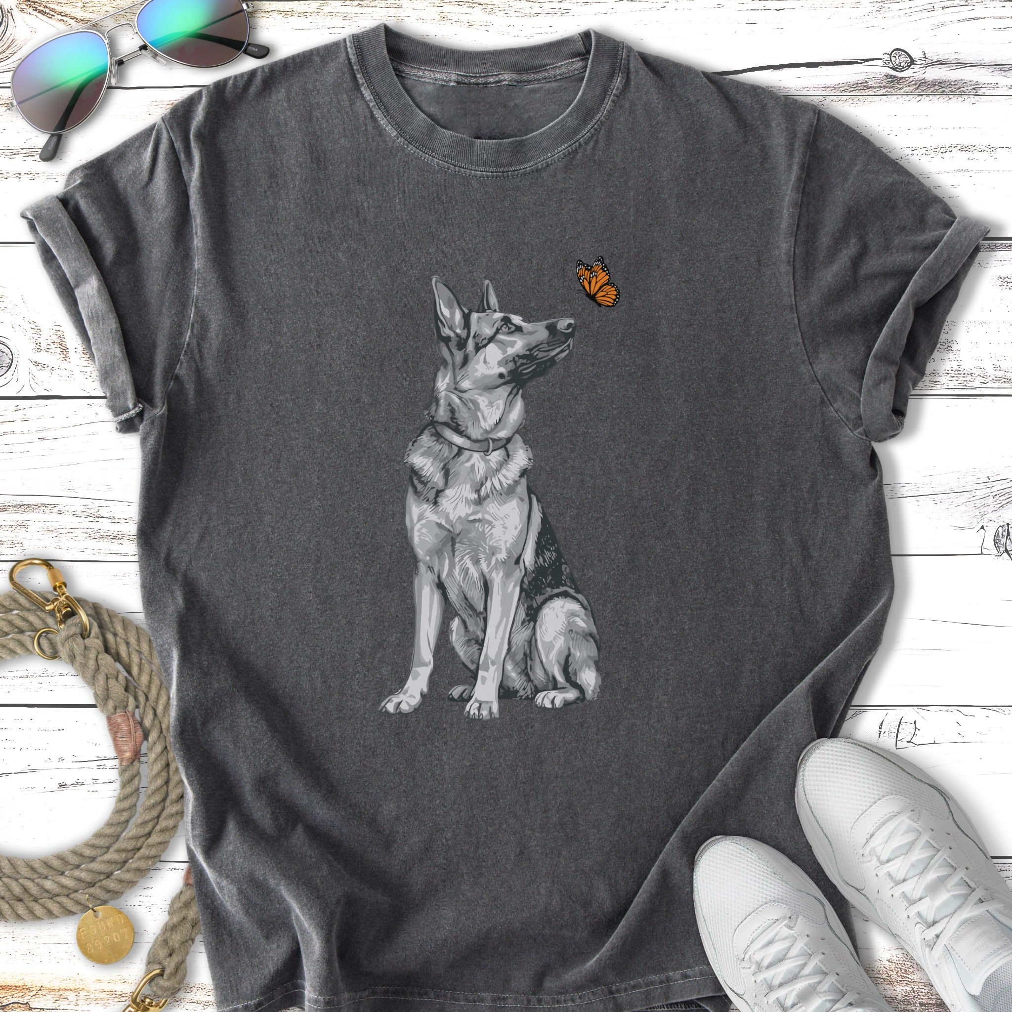 German Shepherd looking at a butterfly, on a charcoal t-shirt.