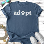 Blue t-shirt with "adopt" and paw print in white text.