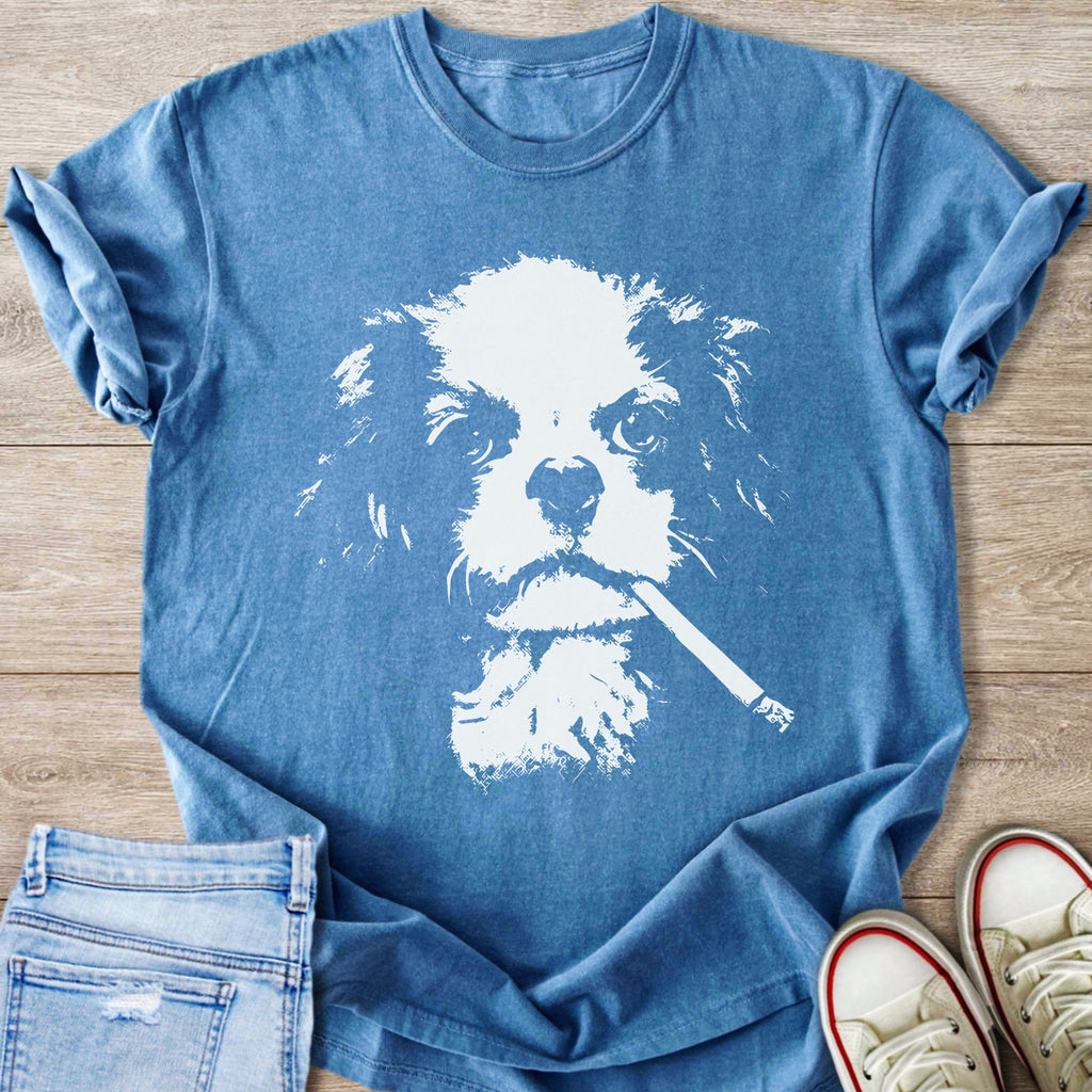 Blue t-shirt with white graphic of a dog's face holding a cigarette.
