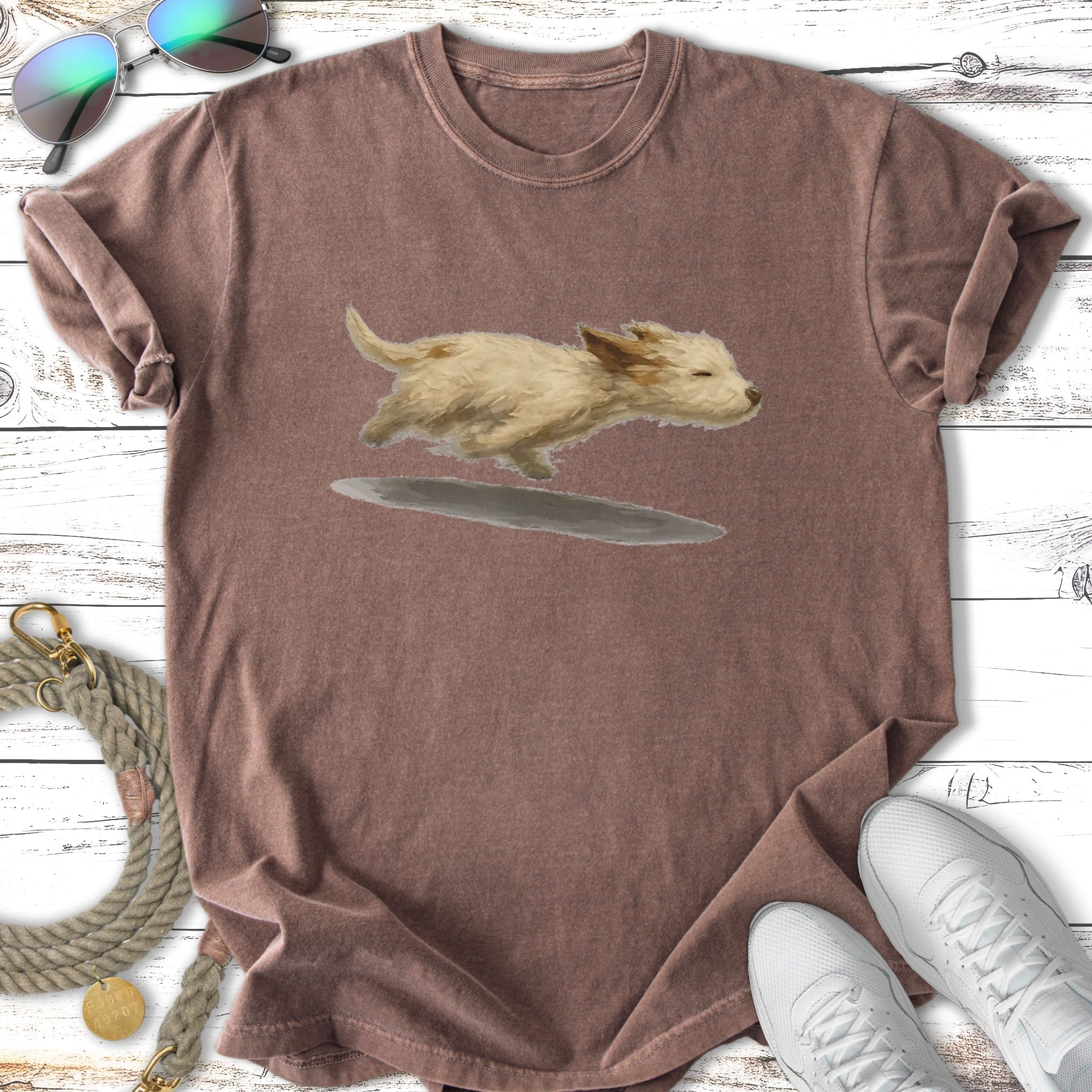 T-shirt with a cartoon drawing of a running tan puppy.