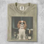 Dog wearing sunglasses sits by champagne bottle and glass.
