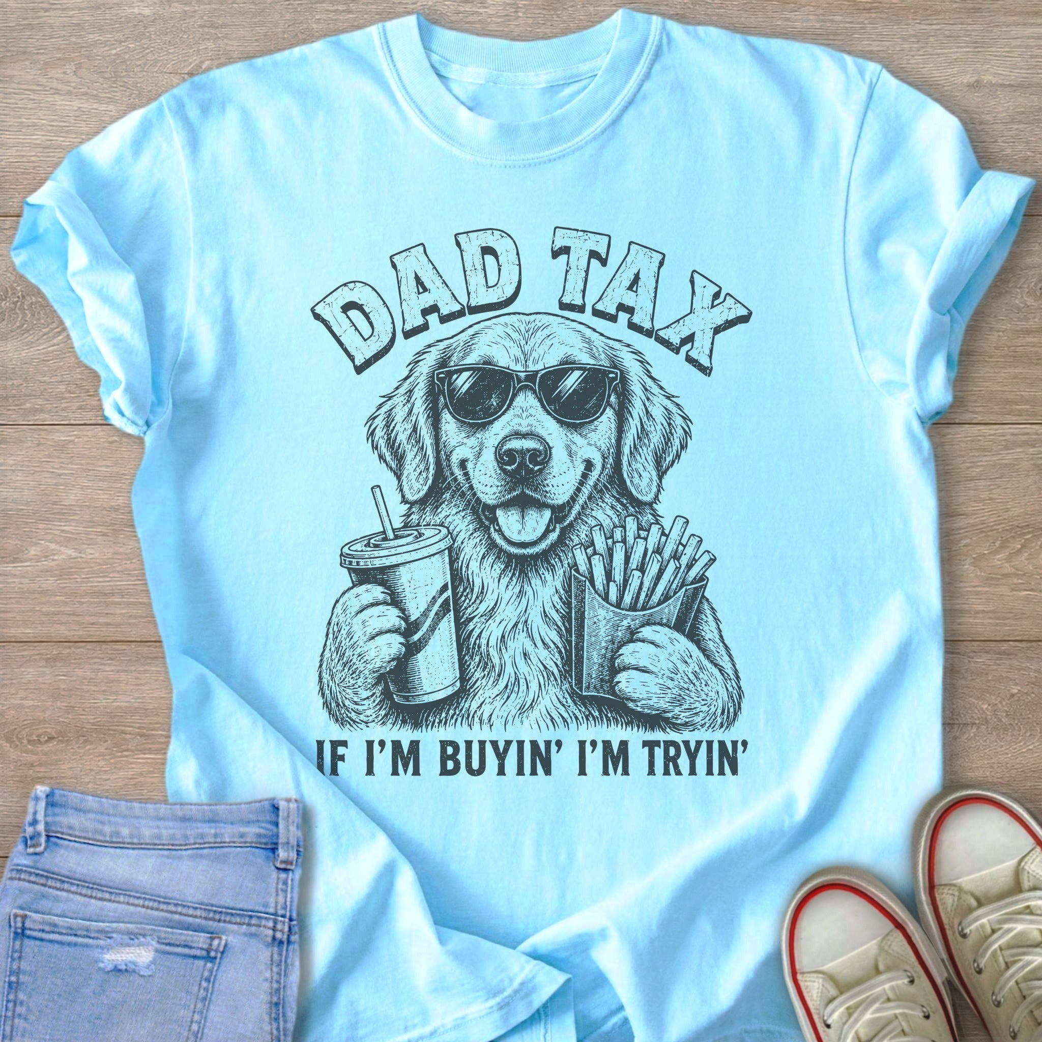 Light blue t-shirt with a drawing of a dog wearing sunglasses, holding a drink and fries.
