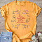 Orange t-shirt with blue dachshund outlines and red text reading "less meanies more weenies".