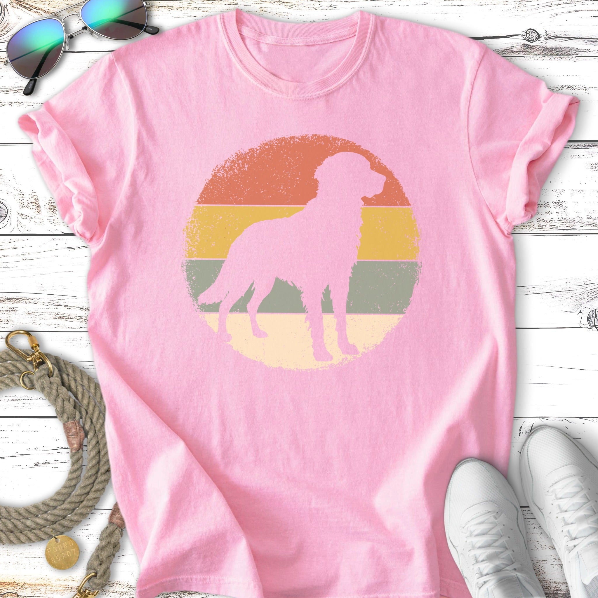 Pink t-shirt with silhouette of a dog in a vintage circle graphic.