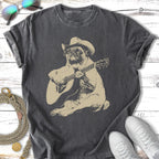 Pug wearing a cowboy hat plays an acoustic guitar.
