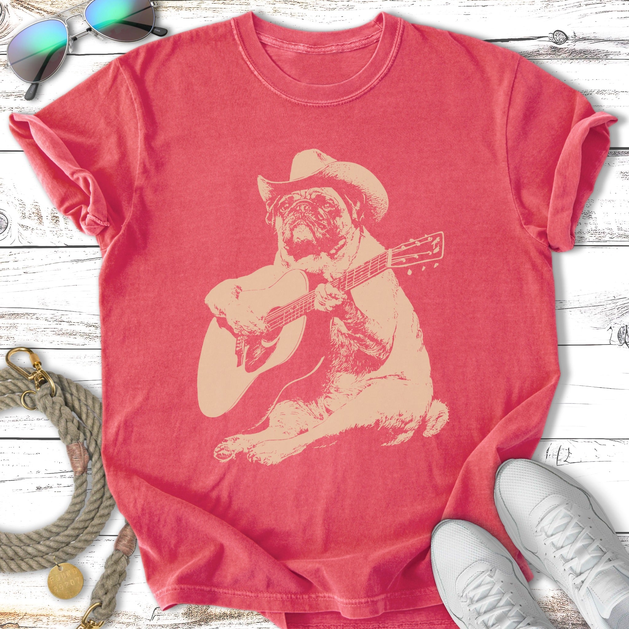 Pug wearing a cowboy hat plays a guitar.