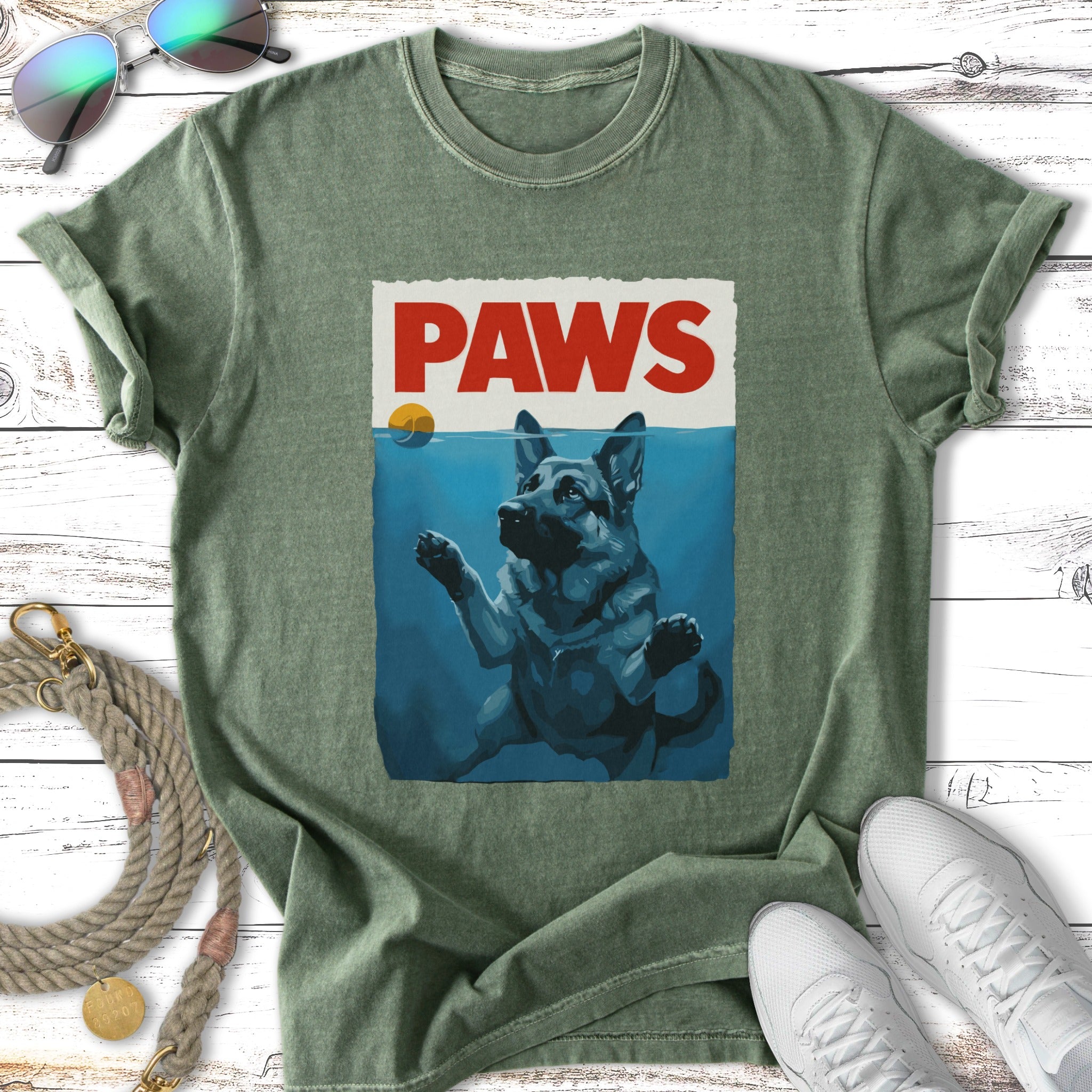 German Shepherd dog surfacing from water under "PAWS" text.