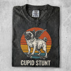 Winged pug on a skateboard with sunset background and "CUPID STUNT" text.
