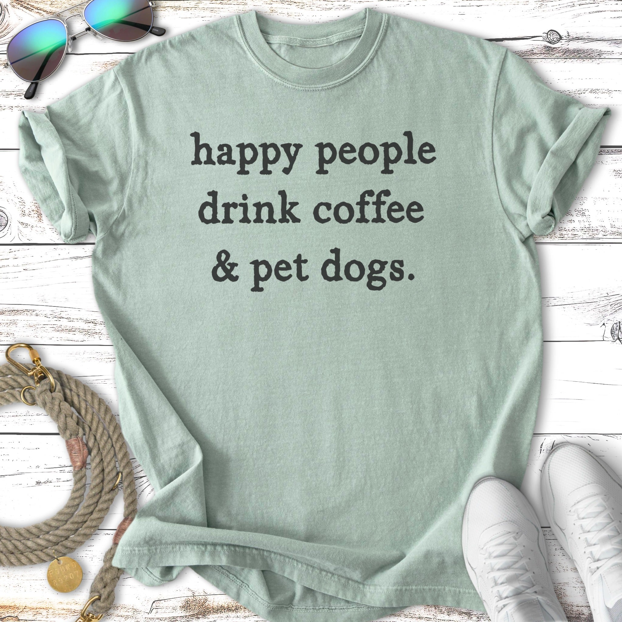 Light mint t-shirt with black text "happy people drink coffee & pet dogs."