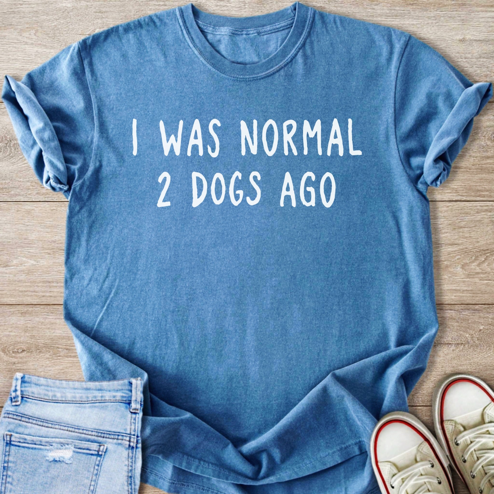 Blue t-shirt with white text "I WAS NORMAL 2 DOGS AGO"