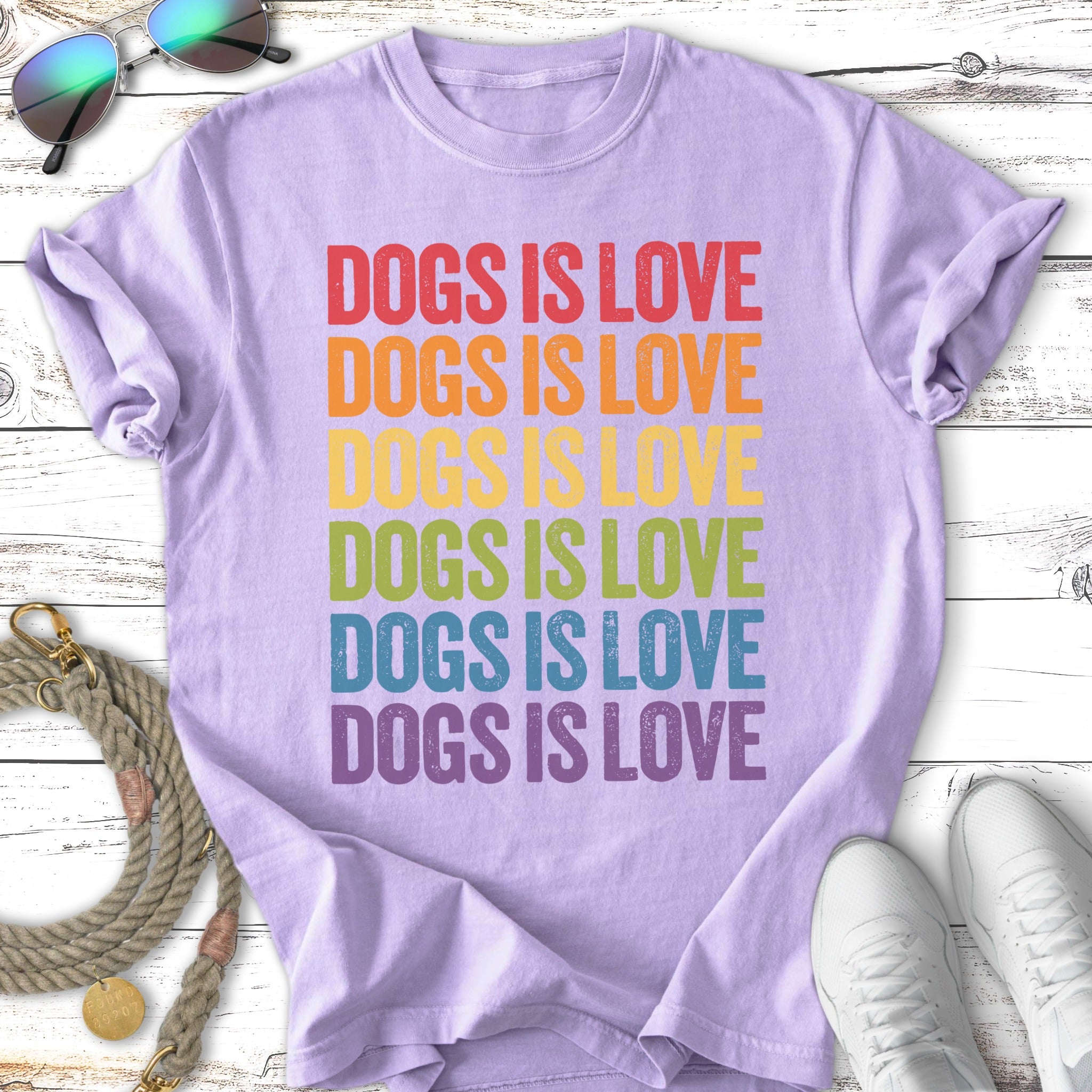 Lavender t-shirt with "DOGS IS LOVE" in rainbow gradient text.