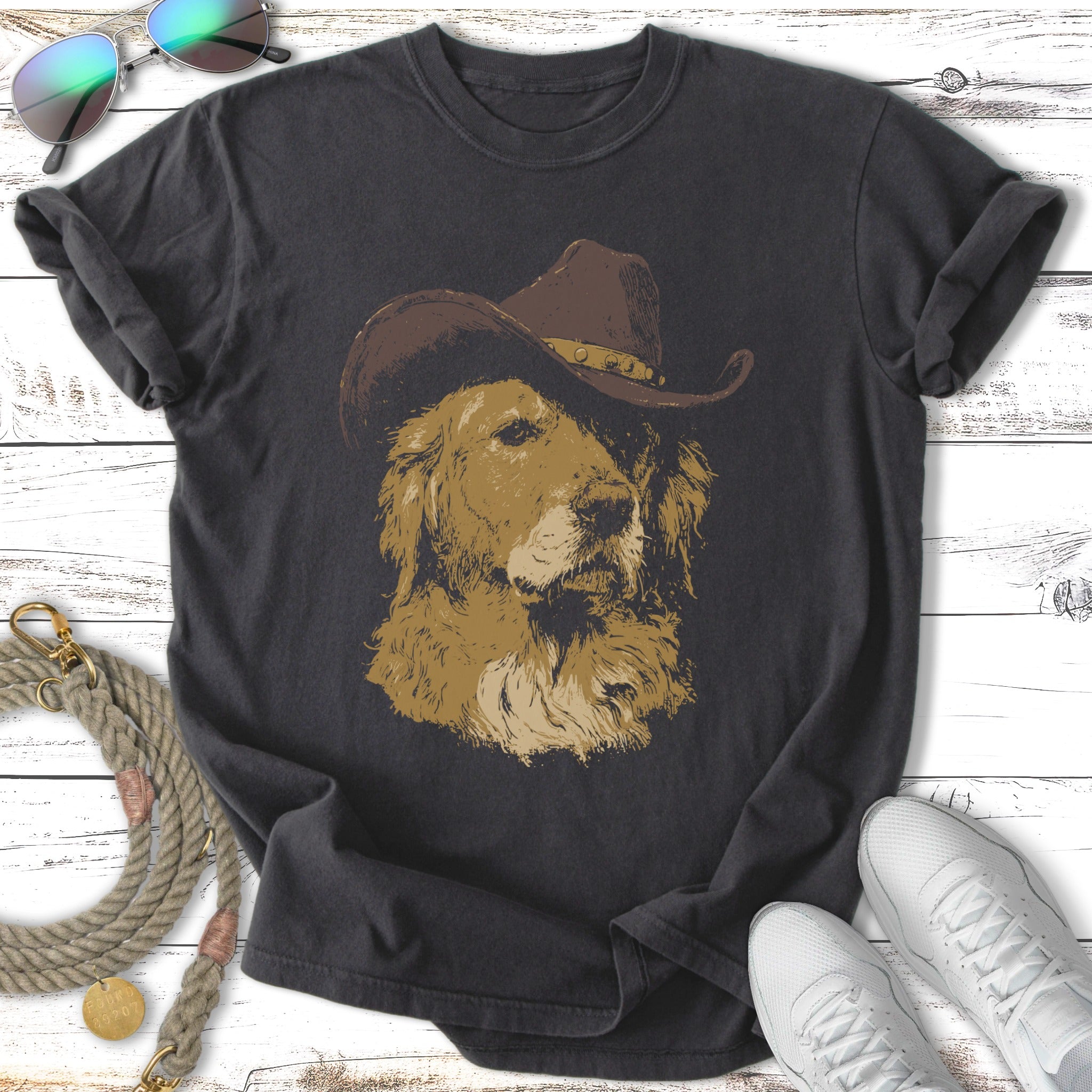Golden retriever wearing a cowboy hat on a charcoal t-shirt.