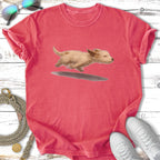 Coral t-shirt with illustration of a dog running through water.