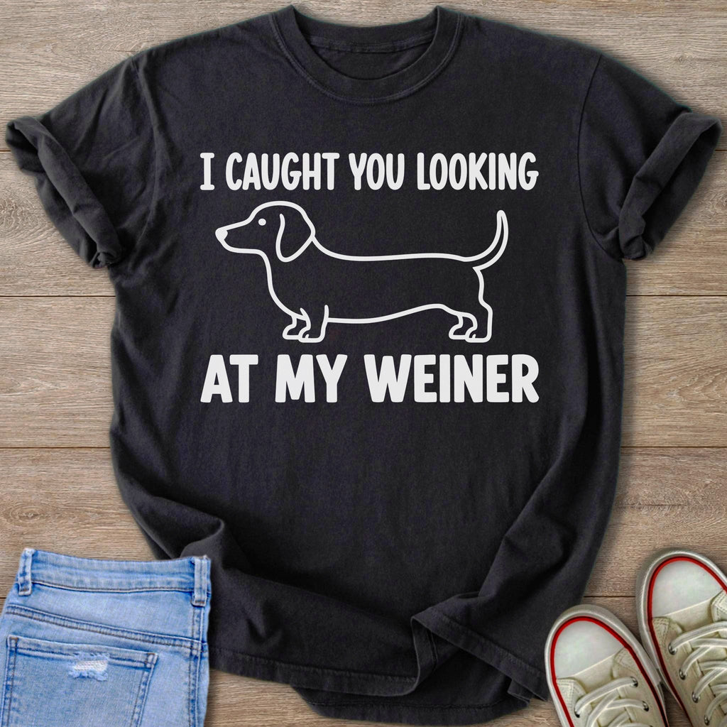 Black t-shirt with white text and dachshund graphic: "I CAUGHT YOU LOOKING AT MY WEINER".