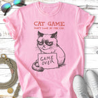 Pink t-shirt with grumpy cat graphic and text "CAT GAME DON'T LOOK AT THE CAT. GAME OVER."