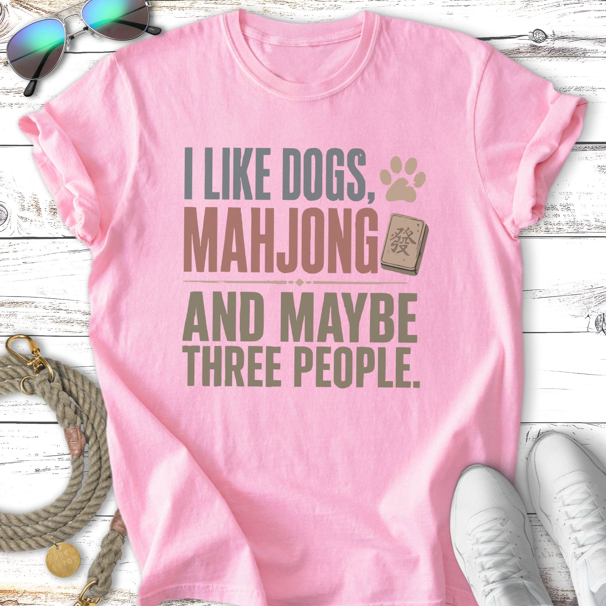 Pink t-shirt with text: "I like dogs, mahjong and maybe three people."