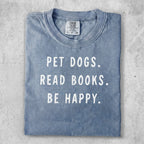 Blue t-shirt with "PET DOGS. READ BOOKS. BE HAPPY." text.
