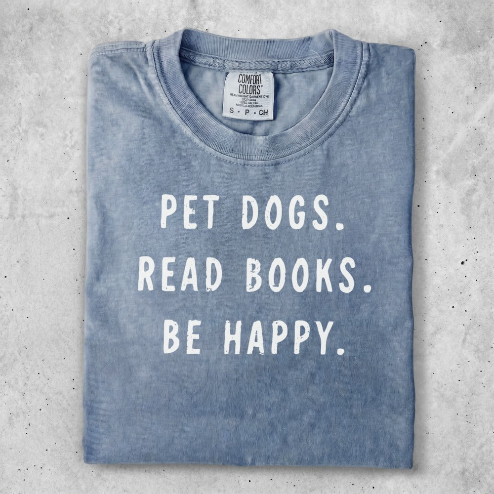 Blue t-shirt with "PET DOGS. READ BOOKS. BE HAPPY." text.