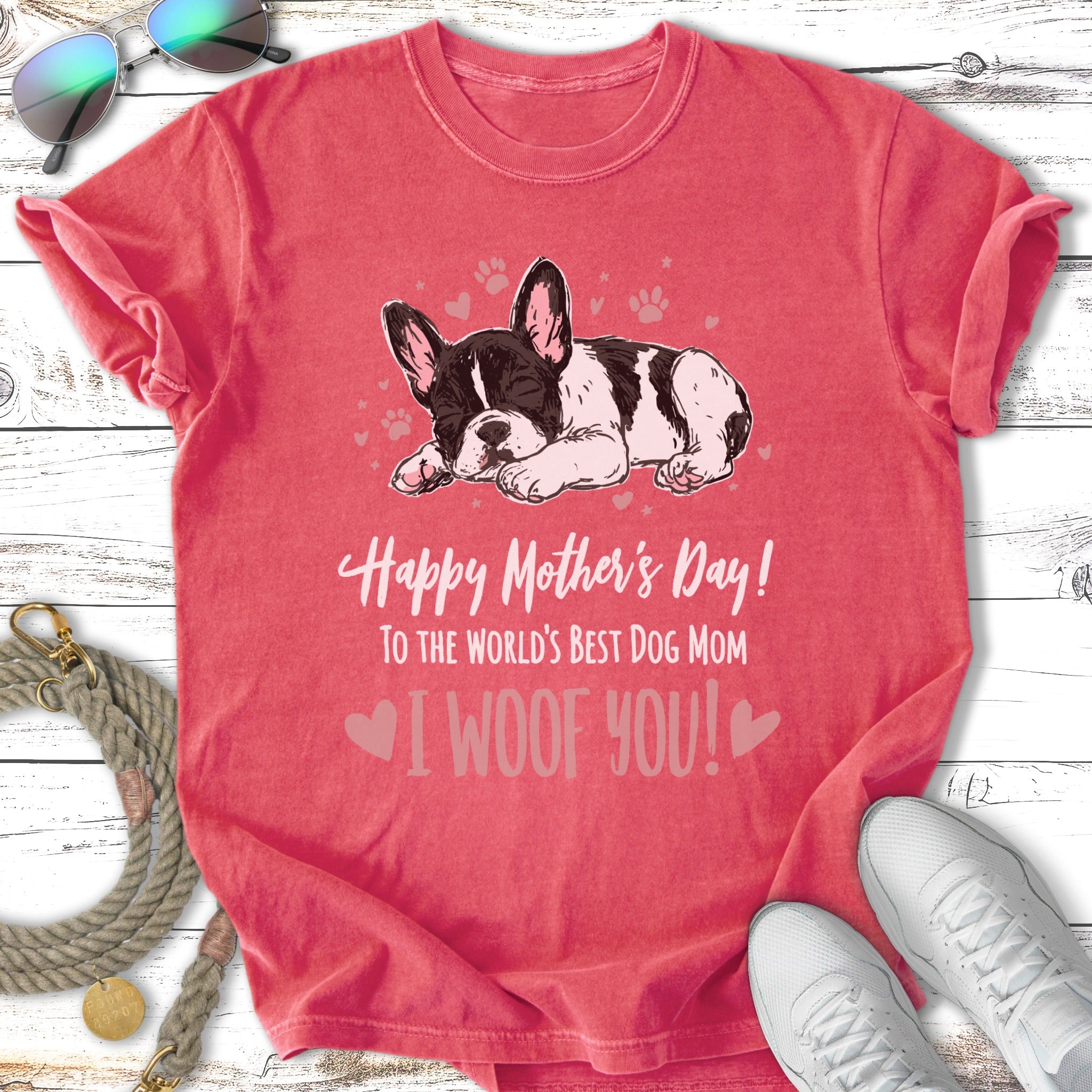 French bulldog sleeping on a distressed pink t-shirt with "I WOOF YOU!" text.