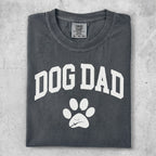 Comfort Colors dog dad t-shirt with paw print graphic.