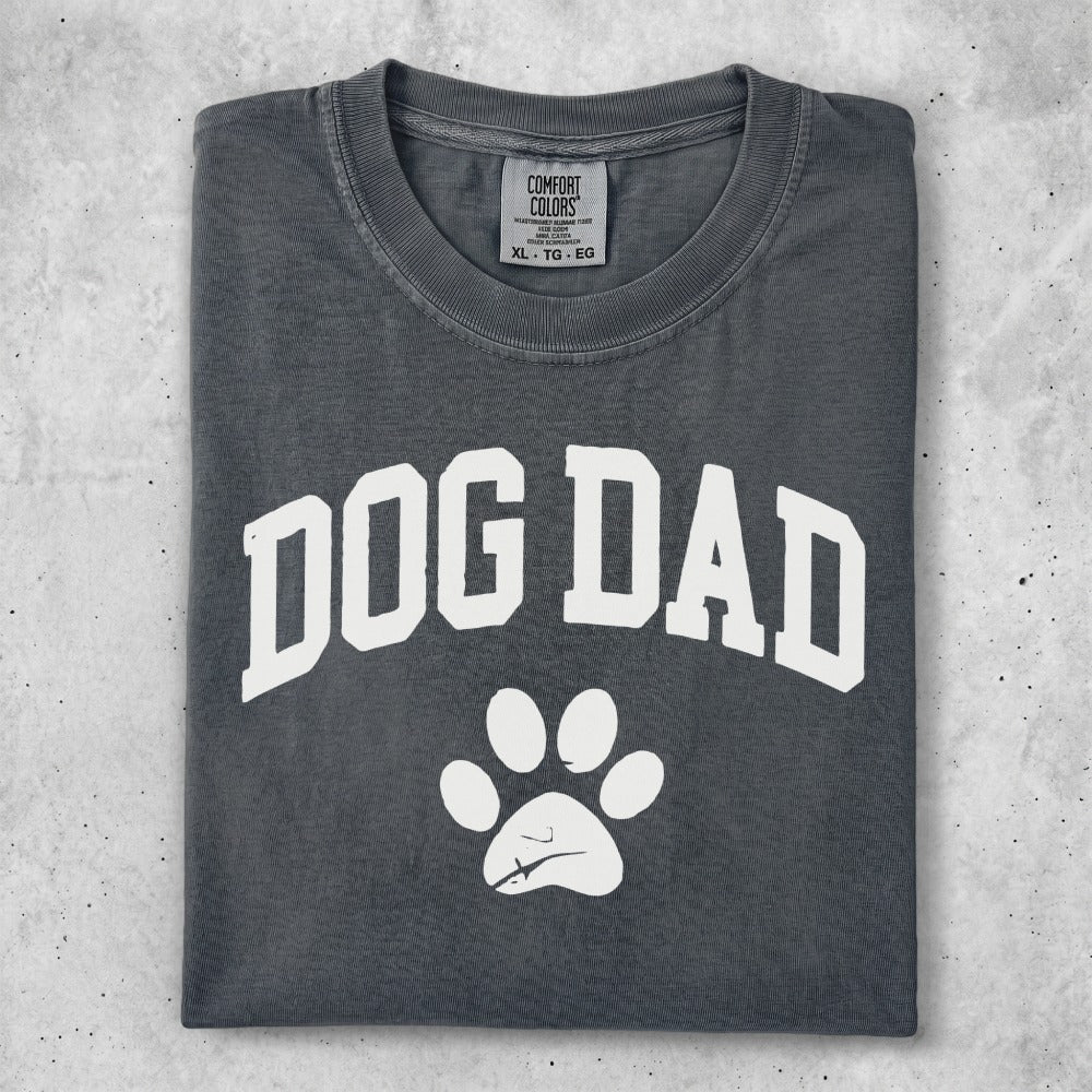 Comfort Colors dog dad t-shirt with paw print graphic.