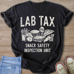 Black t-shirt with "LAB TAX SNACK SAFETY INSPECTION UNIT" text and drawings of snacks.