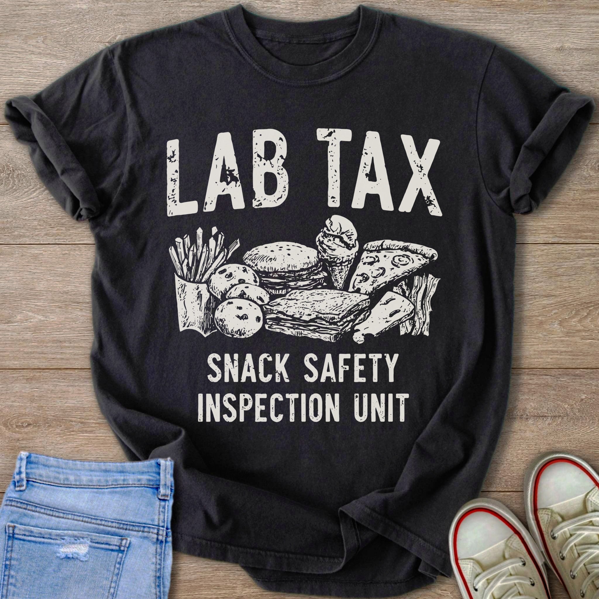 Black t-shirt with "LAB TAX SNACK SAFETY INSPECTION UNIT" text and drawings of snacks.