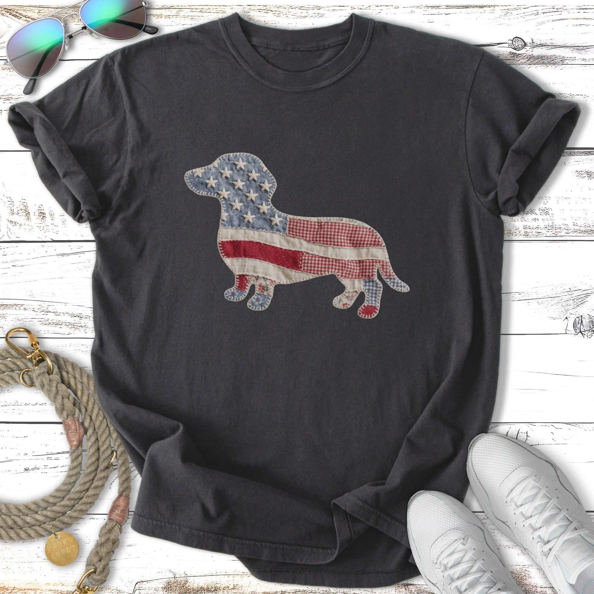 Dachshund silhouette with American flag and plaid patchwork on charcoal t-shirt.